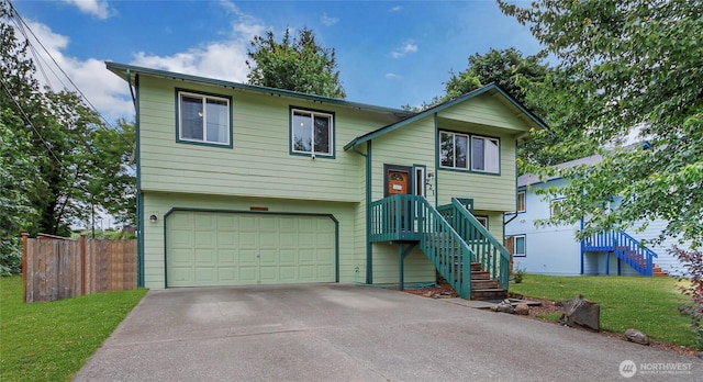 221 S Prairie Carbon River Rd E, South Prairie, WA 98385 - raised ranch with an attached garage, concrete driveway, and stairs