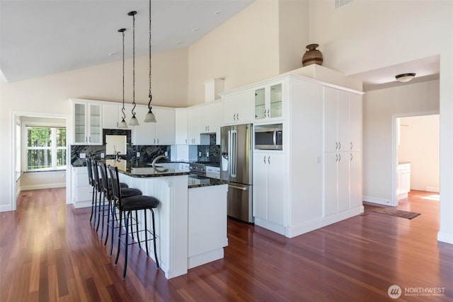 42811 Newaukum Valley Rd, Chehalis, WA 98532 - kitchen with premium appliances, high vaulted ceiling, dark countertops, dark wood-style floors, and a center island with sink