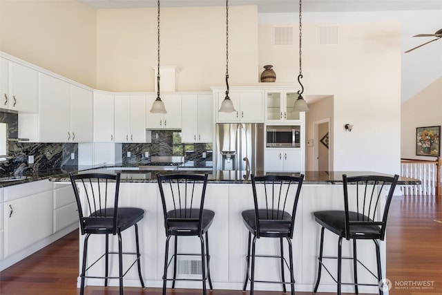 42811 Newaukum Valley Rd, Chehalis, WA 98532 - kitchen featuring stainless steel appliances, a towering ceiling, dark wood-style flooring, backsplash, and white cabinets