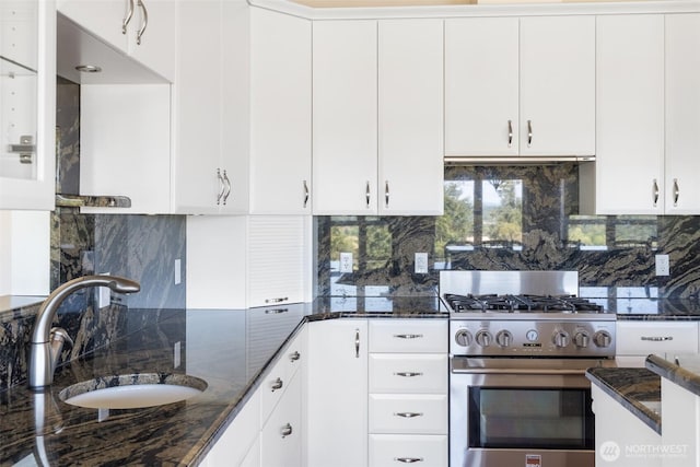 42811 Newaukum Valley Rd, Chehalis, WA 98532 - kitchen with gas stove, tasteful backsplash, dark stone counters, and white cabinetry