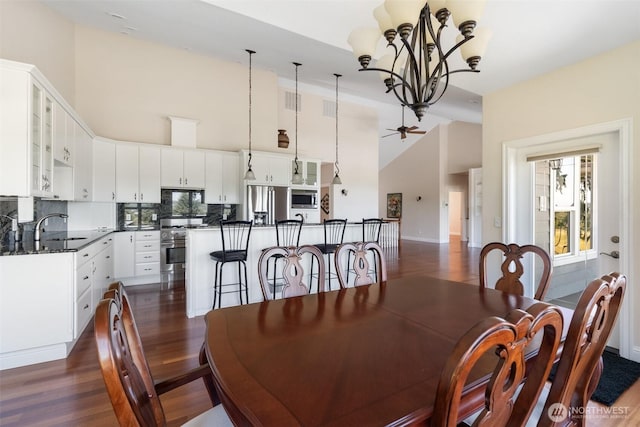 42811 Newaukum Valley Rd, Chehalis, WA 98532 - dining space with dark wood-style floors, high vaulted ceiling, a chandelier, and ceiling fan