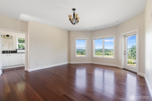 42811 Newaukum Valley Rd, Chehalis, WA 98532 - unfurnished room with a chandelier and dark wood-style flooring