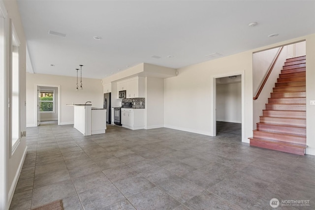 42811 Newaukum Valley Rd, Chehalis, WA 98532 - unfurnished living room with stairs and baseboards
