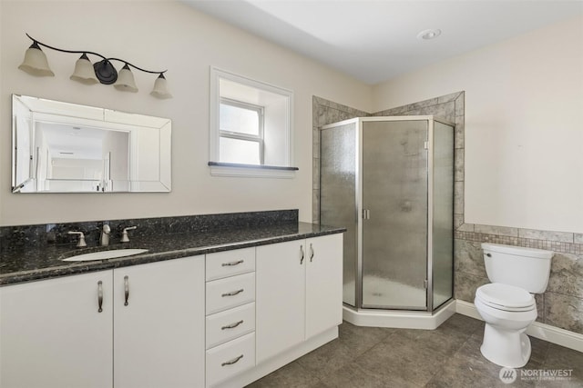 42811 Newaukum Valley Rd, Chehalis, WA 98532 - full bath featuring vanity, a shower stall, tile walls, tile patterned floors, and wainscoting