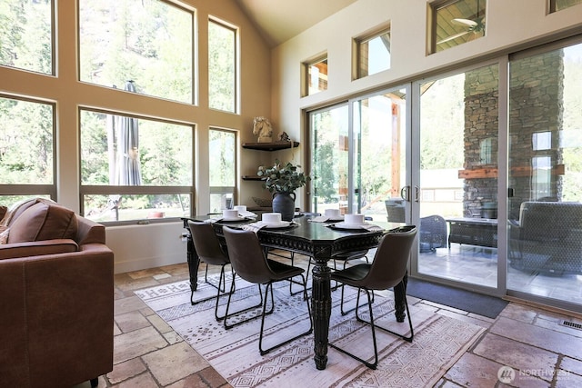 180 Country River Ln, Entiat, WA 98822 - dining room featuring stone tile flooring and high vaulted ceiling