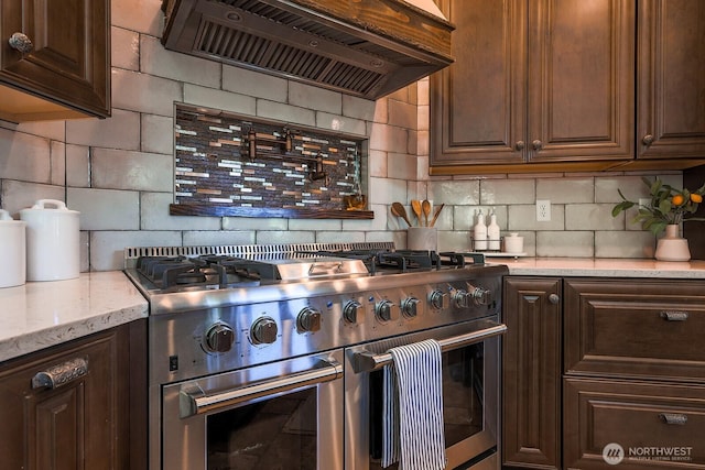 180 Country River Ln, Entiat, WA 98822 - kitchen with range with two ovens, island range hood, decorative backsplash, and dark brown cabinets