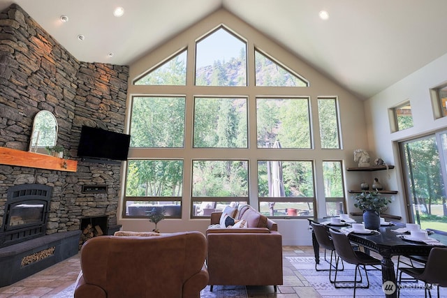 180 Country River Ln, Entiat, WA 98822 - living room with high vaulted ceiling, stone tile floors, a fireplace, and recessed lighting