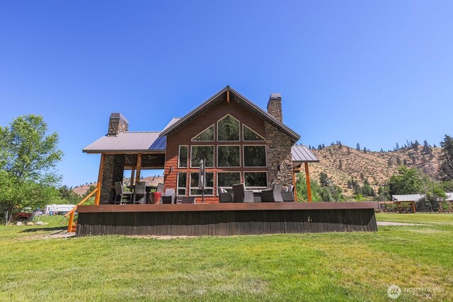 180 Country River Ln, Entiat, WA 98822 - rear view of property with a chimney, a lawn, and a metal roof