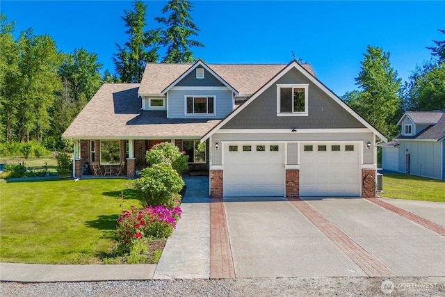 2502 218th St E, Spanaway, WA 98387 - craftsman house with brick siding, driveway, a front yard, covered porch, and a shingled roof