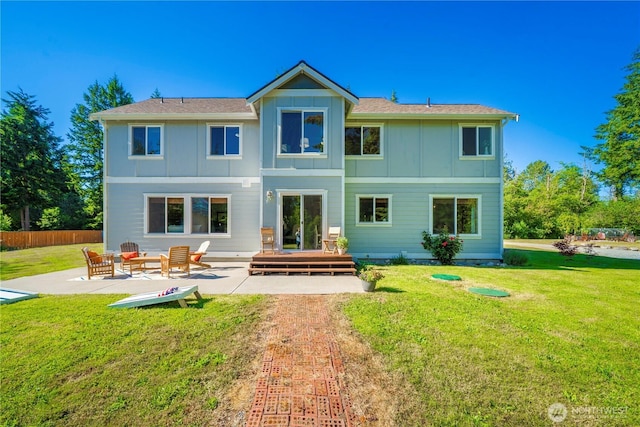 2502 218th St E, Spanaway, WA 98387 - back of property featuring board and batten siding, a patio area, and a wooden deck