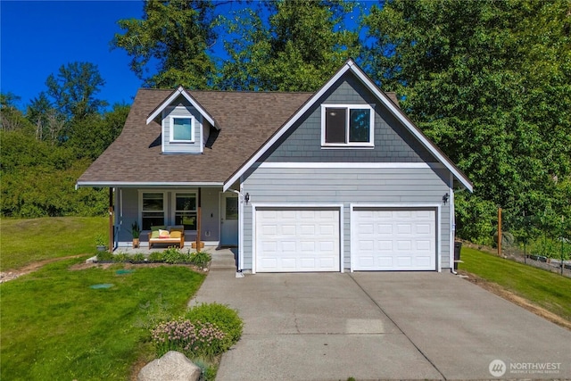 2502 218th St E, Spanaway, WA 98387 - view of front facade with a front yard, driveway, covered porch, a garage, and roof with shingles
