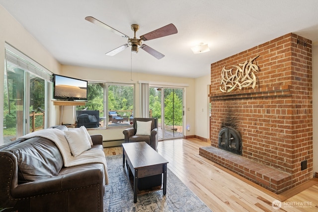 45908 SE Edgewick Rd, North Bend, WA 98045 - living room with baseboard heating, wood finished floors, plenty of natural light, and ceiling fan