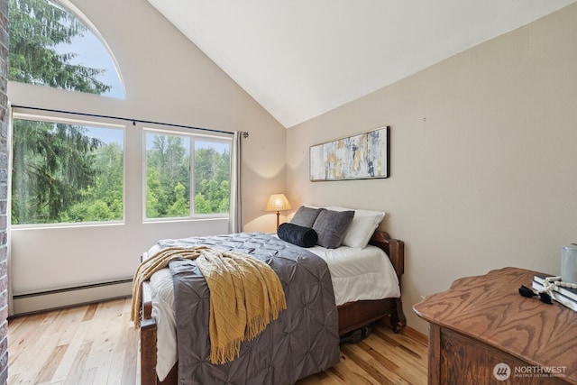 45908 SE Edgewick Rd, North Bend, WA 98045 - bedroom with a baseboard radiator, light wood-style flooring, and high vaulted ceiling