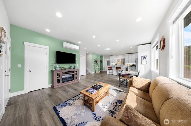 4123 Stuart Cir, Ferndale, WA 98248 - living area featuring wood finished floors, a wall unit AC, and recessed lighting