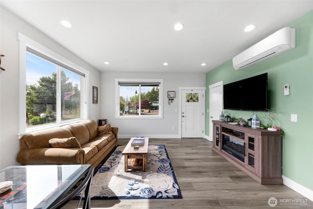 4123 Stuart Cir, Ferndale, WA 98248 - living room featuring an AC wall unit, plenty of natural light, recessed lighting, and wood finished floors
