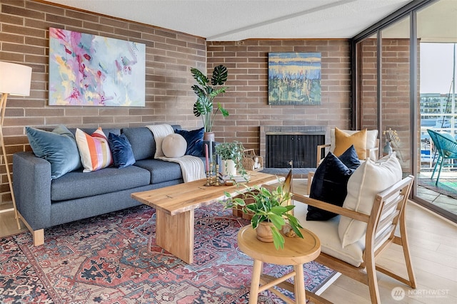 9500 Rainier Ave S Unit 303, Seattle, WA 98118 - living room with a fireplace, brick wall, and wood finished floors