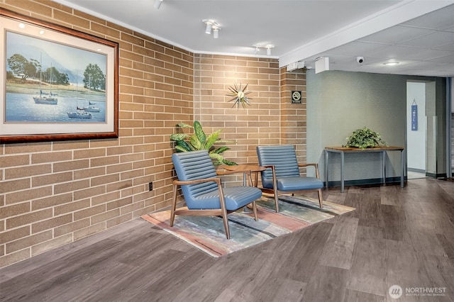 9500 Rainier Ave S Unit 303, Seattle, WA 98118 - sitting room with brick wall and wood finished floors