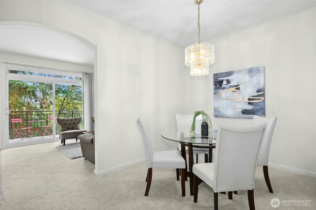 2840 139th Ave SE Unit 9, Bellevue, WA 98005 - dining space featuring carpet floors, a chandelier, and arched walkways