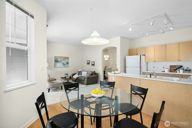 2840 139th Ave SE Unit 9, Bellevue, WA 98005 - dining room with arched walkways and light wood-style flooring