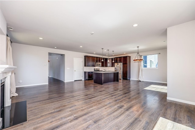 4236 SW Colbert Way, Port Orchard, WA 98367 - unfurnished living room featuring baseboards, recessed lighting, a fireplace, dark wood finished floors, and a sink
