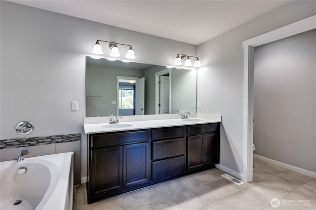 4236 SW Colbert Way, Port Orchard, WA 98367 - bathroom featuring double vanity, a garden tub, toilet, tile patterned flooring, and baseboards