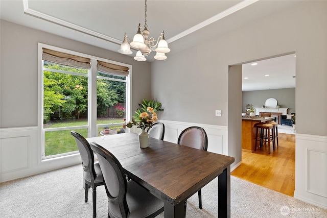 11318 34th Dr SE, Everett, WA 98208 - dining area featuring a chandelier, wainscoting, light colored carpet, ornamental molding, and a decorative wall