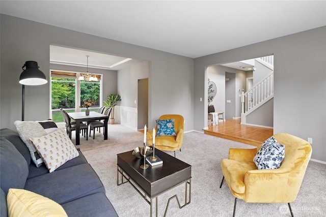 11318 34th Dr SE, Everett, WA 98208 - carpeted living room with wainscoting, stairs, and a chandelier