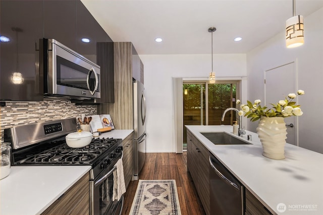 721 26th Ave S Unit B, Seattle, WA 98144 - kitchen featuring stainless steel appliances, modern cabinets, dark wood finished floors, light countertops, and tasteful backsplash