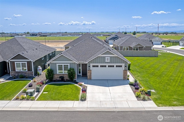 918 N M Loop Dr SW, Quincy, WA 98848 - craftsman house with board and batten siding, stone siding, an attached garage, and concrete driveway