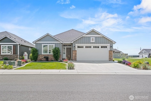 918 N M Loop Dr SW, Quincy, WA 98848 - craftsman-style home featuring board and batten siding, stone siding, a garage, concrete driveway, and a front lawn