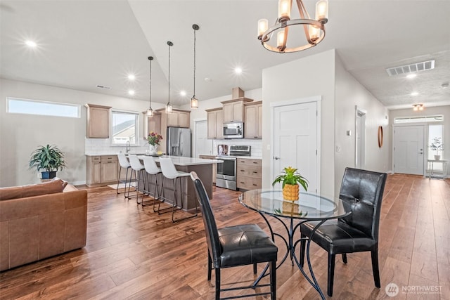 918 N M Loop Dr SW, Quincy, WA 98848 - dining space featuring wood-type flooring, a chandelier, vaulted ceiling, and recessed lighting