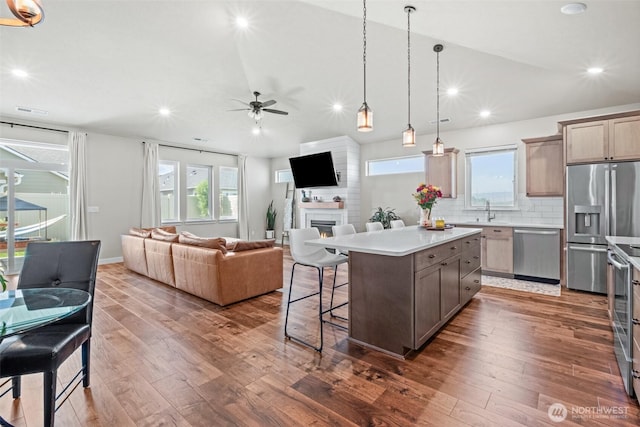 918 N M Loop Dr SW, Quincy, WA 98848 - kitchen featuring stainless steel appliances, open floor plan, a fireplace, a ceiling fan, and recessed lighting