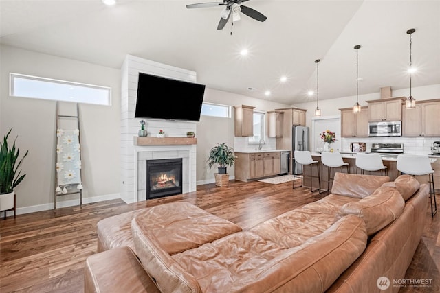 918 N M Loop Dr SW, Quincy, WA 98848 - living area featuring a ceiling fan, a fireplace, wood finished floors, recessed lighting, and high vaulted ceiling