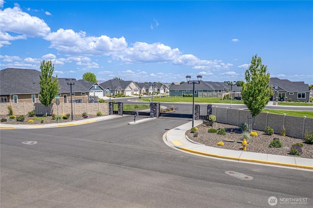 918 N M Loop Dr SW, Quincy, WA 98848 - view of asphalt street with a residential view, street lights, a gate, and curbs