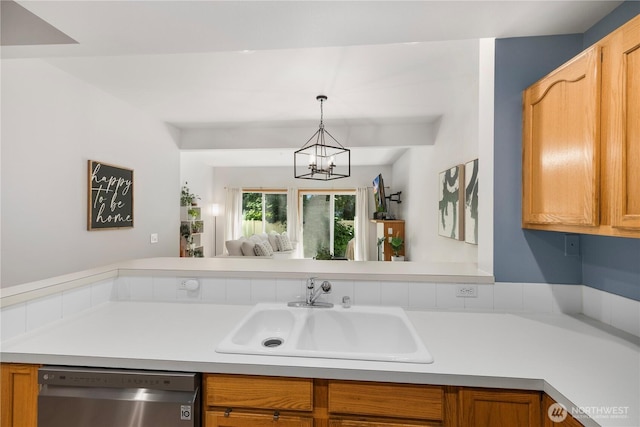 418 17th St SE Unit 5C, Auburn, WA 98002 - kitchen featuring dishwasher, a chandelier, light countertops, hanging light fixtures, and brown cabinets