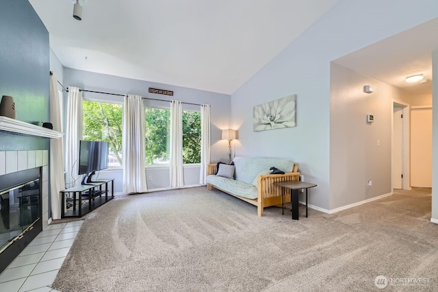 9210 Market Pl Unit F202, Lake Stevens, WA 98258 - living area featuring a tiled fireplace, vaulted ceiling, and carpet