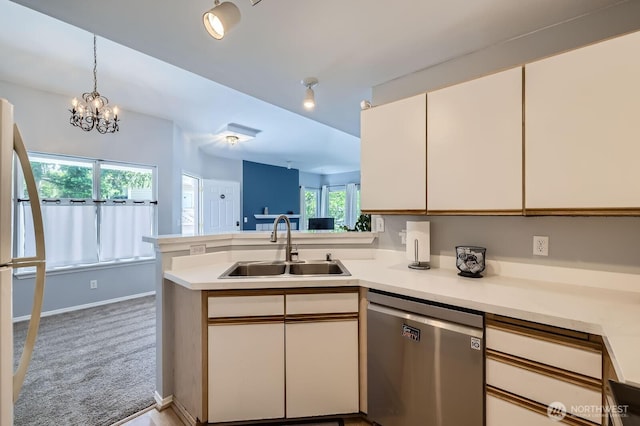 9210 Market Pl Unit F202, Lake Stevens, WA 98258 - kitchen with stainless steel dishwasher, a peninsula, light countertops, and white cabinets