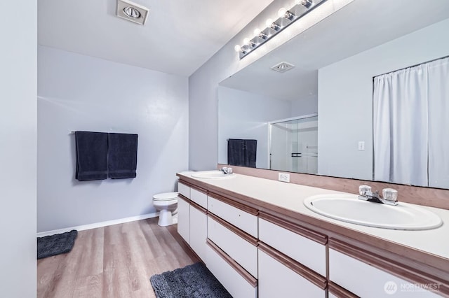 9210 Market Pl Unit F202, Lake Stevens, WA 98258 - full bathroom featuring double vanity, a shower with shower door, and wood finished floors