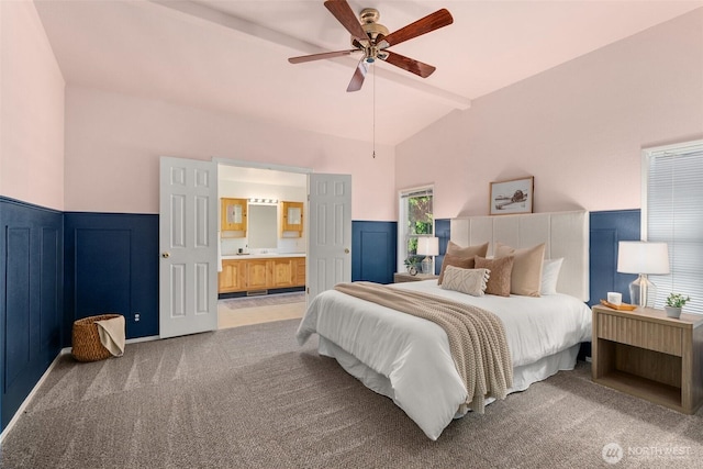 187 Dusty Ln, Chehalis, WA 98532 - bedroom featuring light carpet, a wainscoted wall, vaulted ceiling, ensuite bath, and a ceiling fan