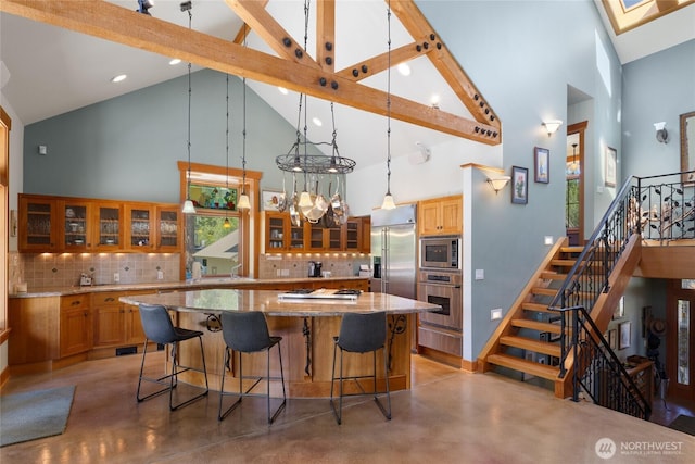 401 Quail Valley Rd, Cle Elum, WA 98922 - kitchen with built in appliances, high vaulted ceiling, decorative backsplash, finished concrete floors, and glass insert cabinets