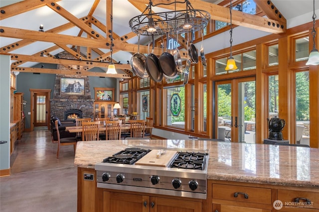 401 Quail Valley Rd, Cle Elum, WA 98922 - kitchen featuring stainless steel gas cooktop, healthy amount of natural light, high vaulted ceiling, open floor plan, and finished concrete flooring
