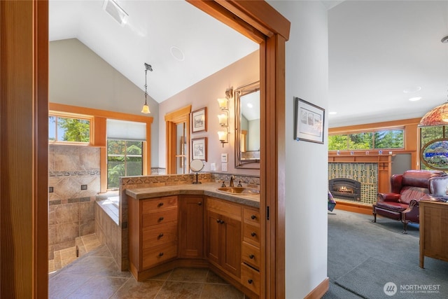 401 Quail Valley Rd, Cle Elum, WA 98922 - full bath featuring vanity, a lit fireplace, and high vaulted ceiling