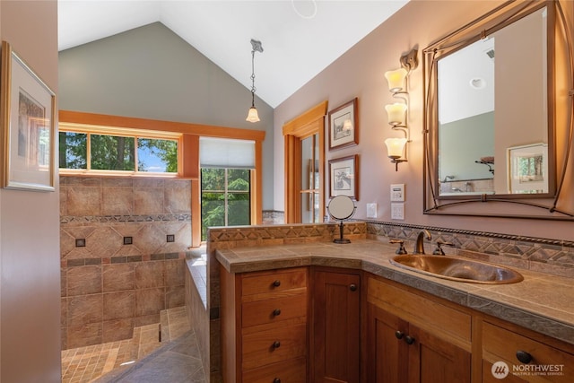 401 Quail Valley Rd, Cle Elum, WA 98922 - bathroom with vaulted ceiling, vanity, a walk in shower, and decorative backsplash