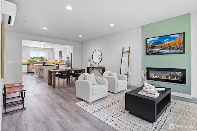 17905 35th Ave SE Unit C3, Bothell, WA 98012 - living room featuring recessed lighting, light wood-type flooring, and a glass covered fireplace