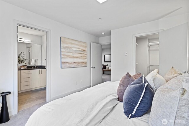 17905 35th Ave SE Unit C3, Bothell, WA 98012 - bedroom featuring connected bathroom, a spacious closet, and light colored carpet