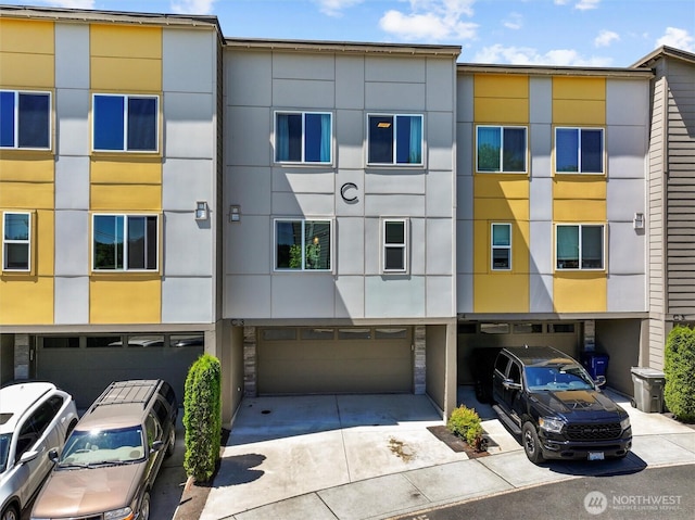 17905 35th Ave SE Unit C3, Bothell, WA 98012 - view of building exterior featuring an attached garage and driveway