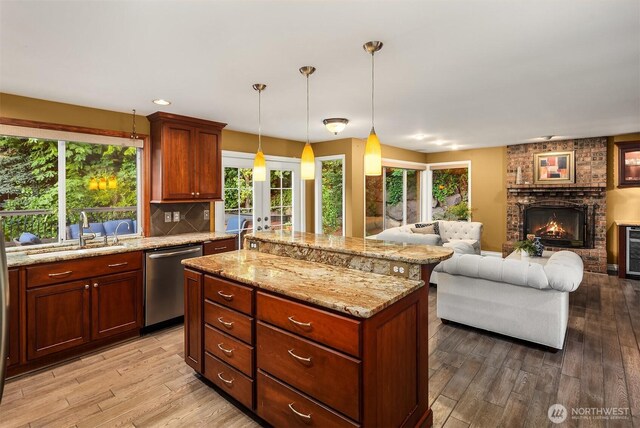 15214 102nd Ave NE, Bothell, WA 98011 - kitchen featuring dishwasher, open floor plan, light wood finished floors, light stone counters, and a center island