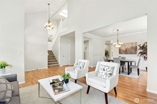 3303 174th Pl SE, Bothell, WA 98012 - living room featuring a chandelier, stairway, light wood finished floors, and a towering ceiling