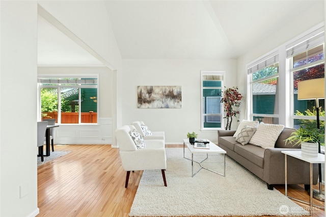 3303 174th Pl SE, Bothell, WA 98012 - living area with wood finished floors, healthy amount of natural light, a wainscoted wall, high vaulted ceiling, and a decorative wall
