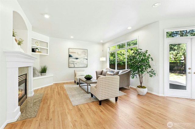 3303 174th Pl SE, Bothell, WA 98012 - living room with light wood finished floors, built in features, recessed lighting, and a fireplace